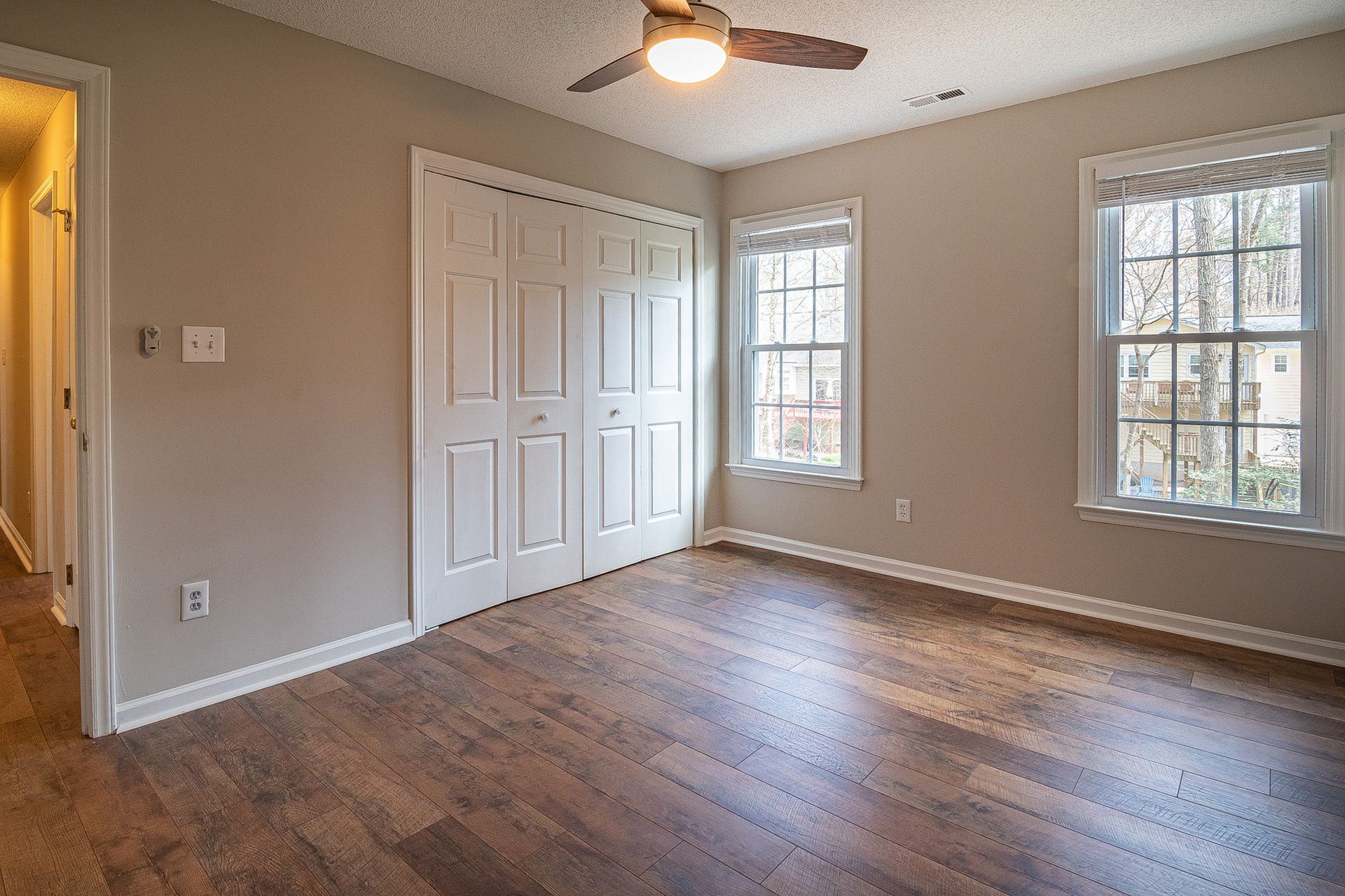 Empty living room with hardwood floors cleaned and ready for new occupants after a move-out clean