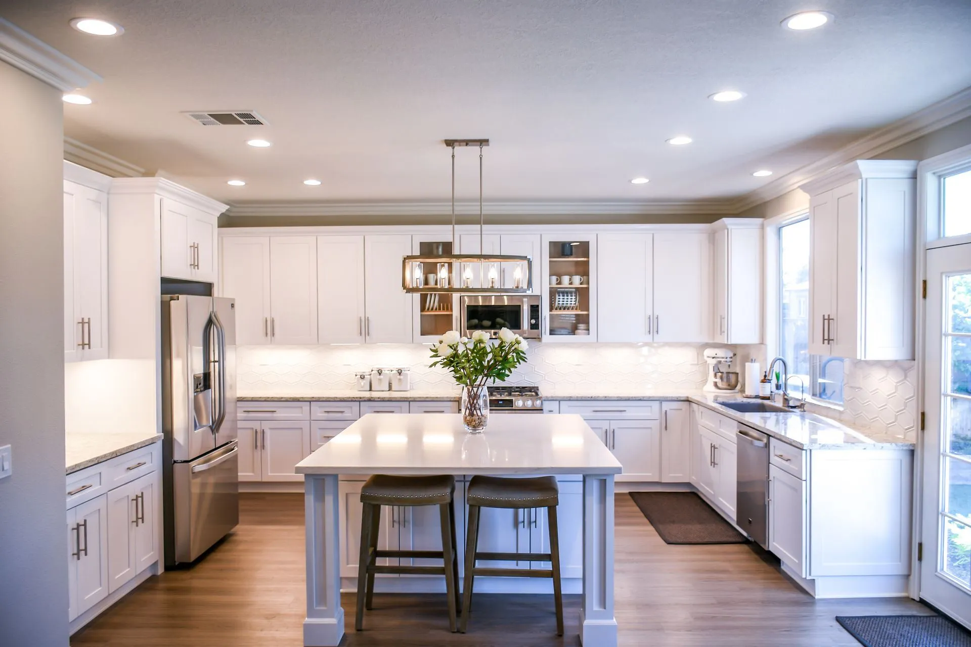 Bright, freshly cleaned white kitchen with an island in a Louisville-area home