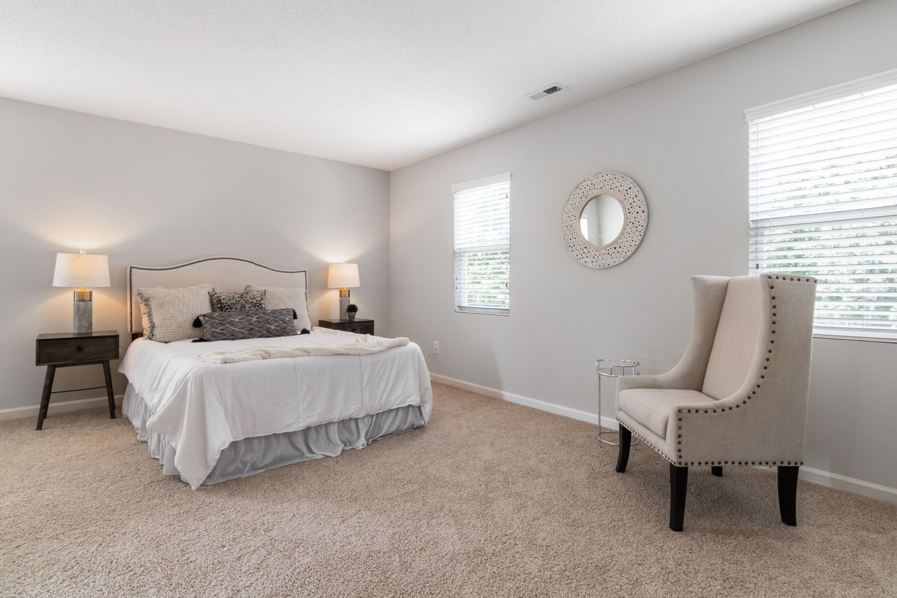 Short-term rental bedroom staged with fresh linens after turnover cleaning