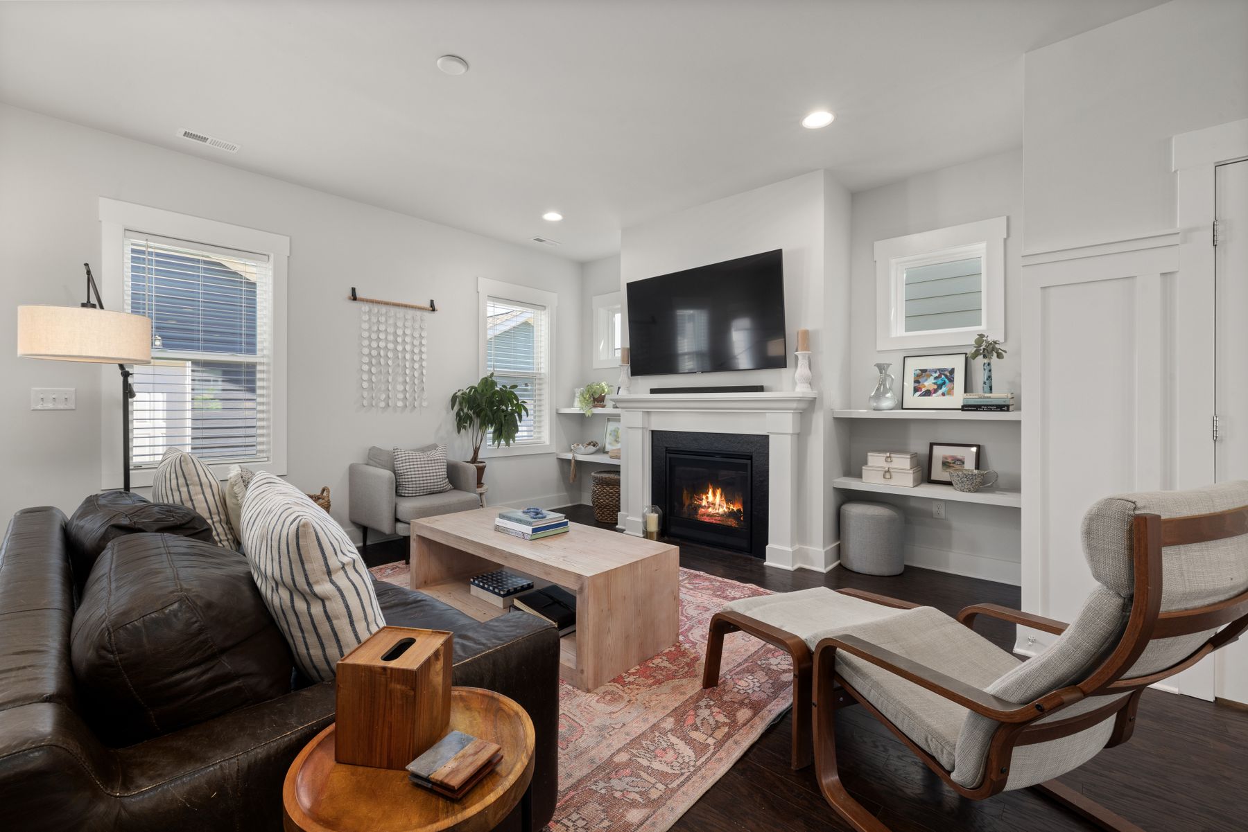 Bright, freshly cleaned living room with a fireplace in a Louisville single-family home